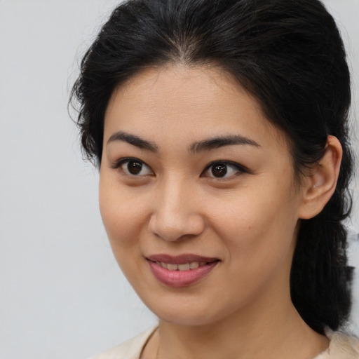 Joyful asian young-adult female with medium  brown hair and brown eyes