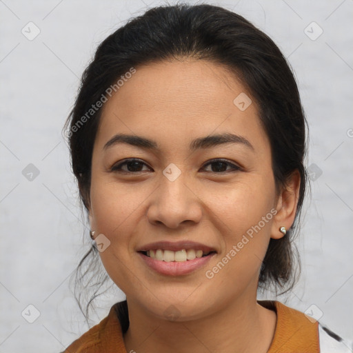 Joyful latino young-adult female with medium  brown hair and brown eyes