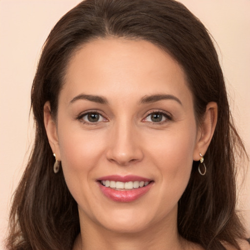 Joyful white young-adult female with long  brown hair and brown eyes