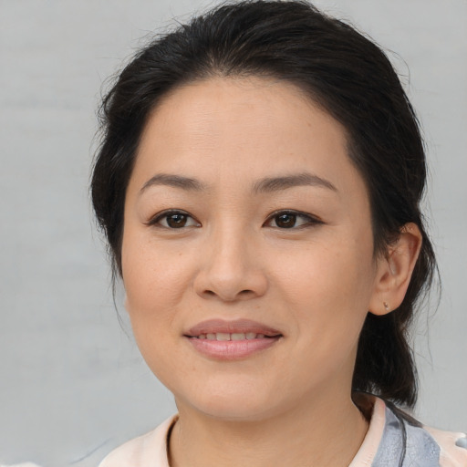 Joyful asian young-adult female with medium  brown hair and brown eyes