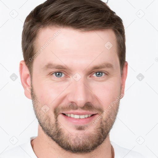 Joyful white young-adult male with short  brown hair and grey eyes