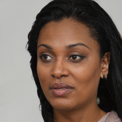 Joyful black adult female with medium  black hair and brown eyes