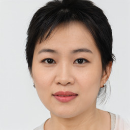 Joyful asian young-adult female with medium  brown hair and brown eyes