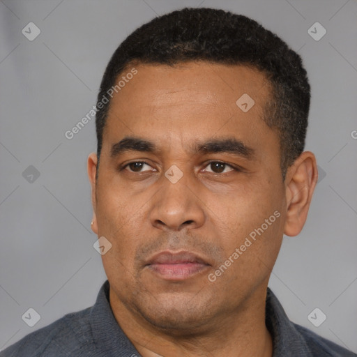Neutral latino adult male with short  black hair and brown eyes