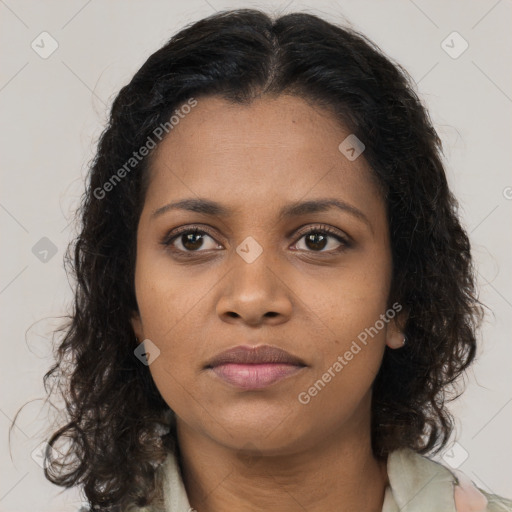Joyful black young-adult female with long  brown hair and brown eyes