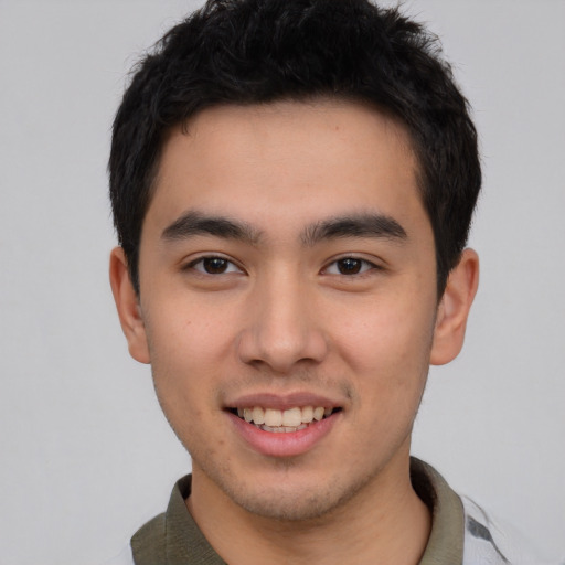 Joyful asian young-adult male with short  black hair and brown eyes