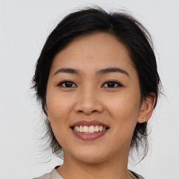 Joyful asian young-adult female with medium  black hair and brown eyes