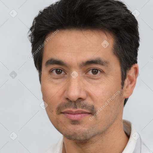 Joyful white adult male with short  black hair and brown eyes