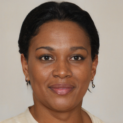 Joyful black adult female with short  brown hair and brown eyes