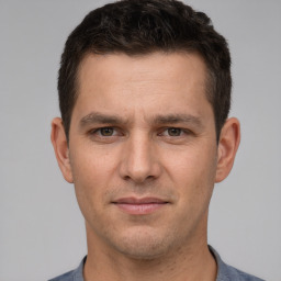 Joyful white young-adult male with short  brown hair and brown eyes