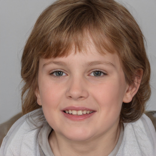 Joyful white child female with medium  brown hair and grey eyes