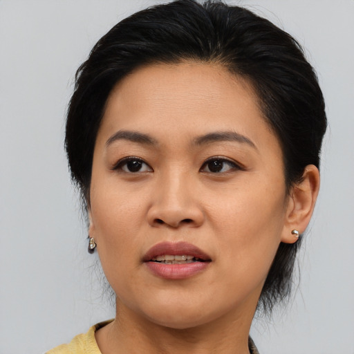 Joyful asian young-adult female with medium  brown hair and brown eyes