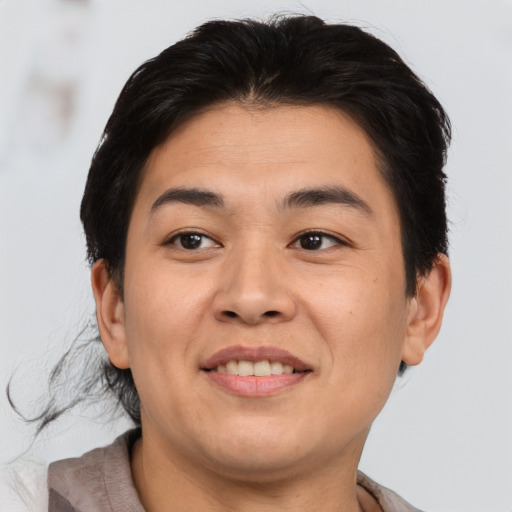 Joyful asian young-adult male with short  brown hair and brown eyes