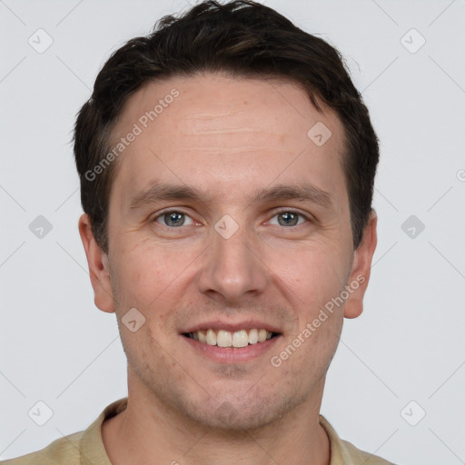 Joyful white young-adult male with short  brown hair and grey eyes