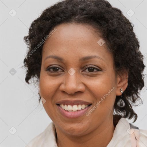 Joyful black adult female with medium  brown hair and brown eyes