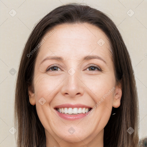 Joyful white adult female with long  brown hair and brown eyes