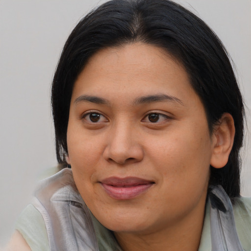 Joyful asian young-adult female with long  brown hair and brown eyes
