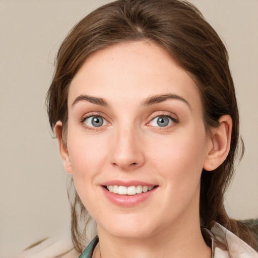 Joyful white young-adult female with medium  brown hair and blue eyes