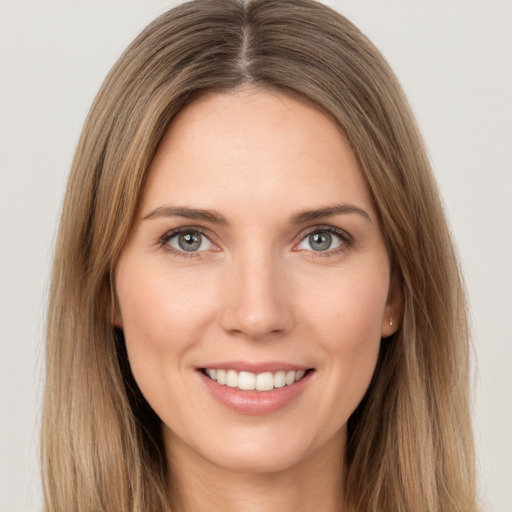 Joyful white young-adult female with long  brown hair and brown eyes