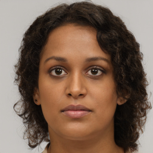 Neutral black young-adult female with medium  brown hair and brown eyes