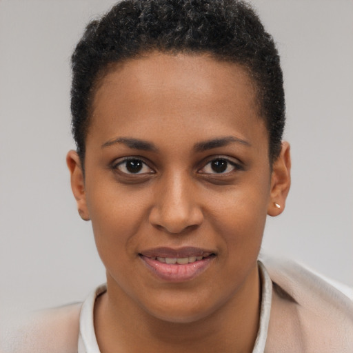 Joyful black young-adult female with short  brown hair and brown eyes
