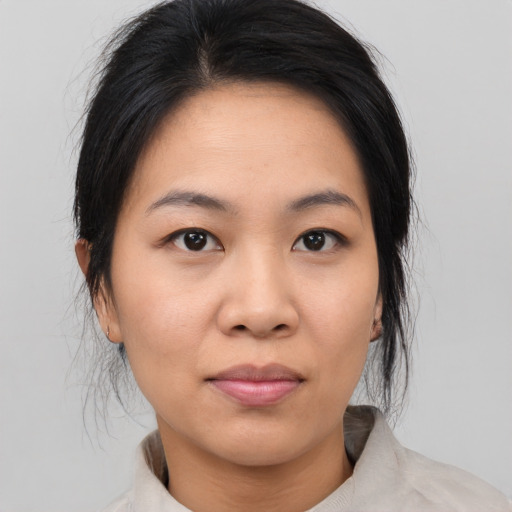 Joyful asian young-adult female with medium  black hair and brown eyes