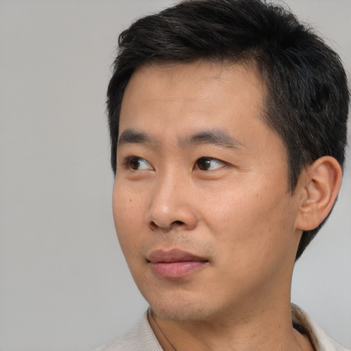 Neutral asian young-adult male with short  black hair and brown eyes