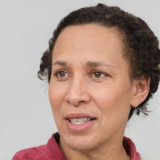 Joyful black adult female with short  brown hair and brown eyes