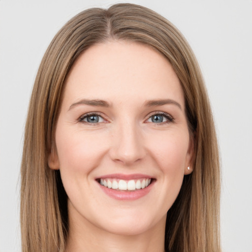 Joyful white young-adult female with long  brown hair and grey eyes