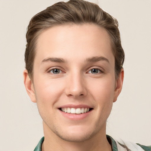 Joyful white young-adult female with short  brown hair and green eyes