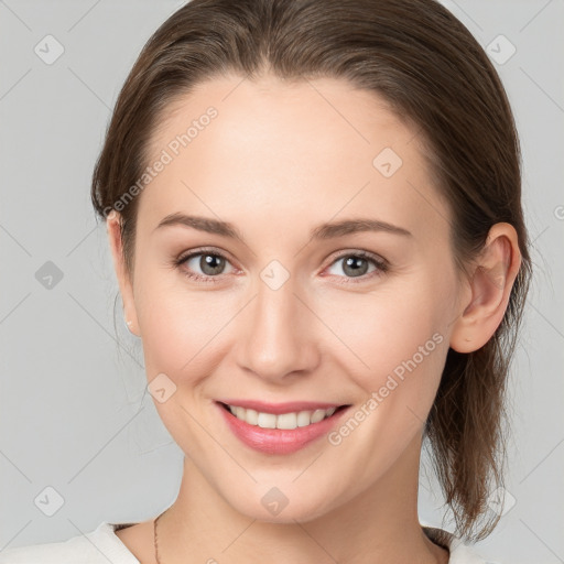 Joyful white young-adult female with medium  brown hair and grey eyes