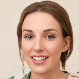 Joyful white young-adult female with medium  brown hair and green eyes