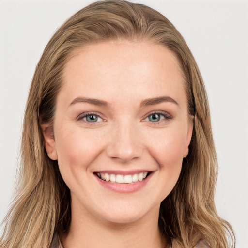 Joyful white young-adult female with long  brown hair and blue eyes