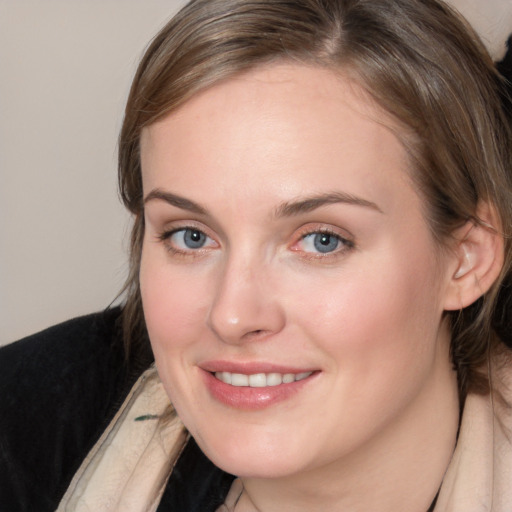 Joyful white young-adult female with medium  brown hair and blue eyes