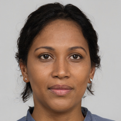 Joyful black adult female with medium  brown hair and brown eyes