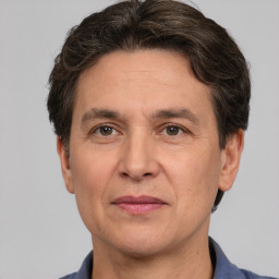 Joyful white adult male with short  brown hair and grey eyes