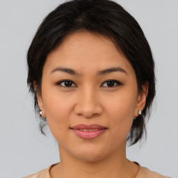 Joyful asian young-adult female with medium  brown hair and brown eyes