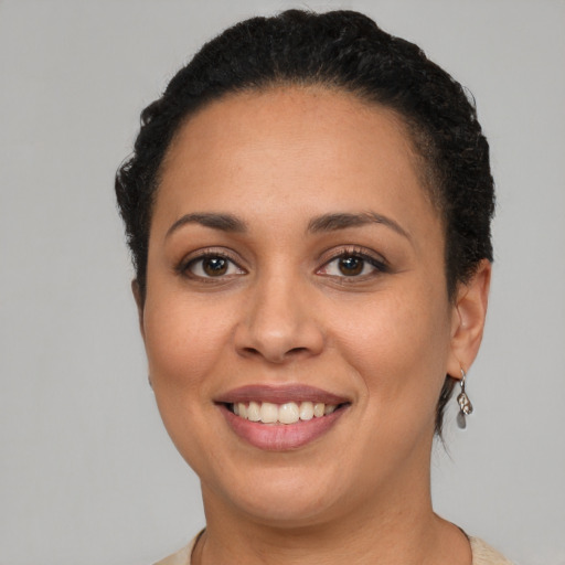 Joyful latino young-adult female with short  brown hair and brown eyes