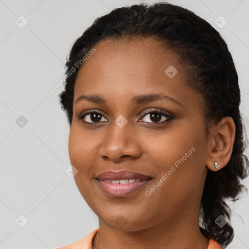 Joyful black young-adult female with medium  black hair and brown eyes