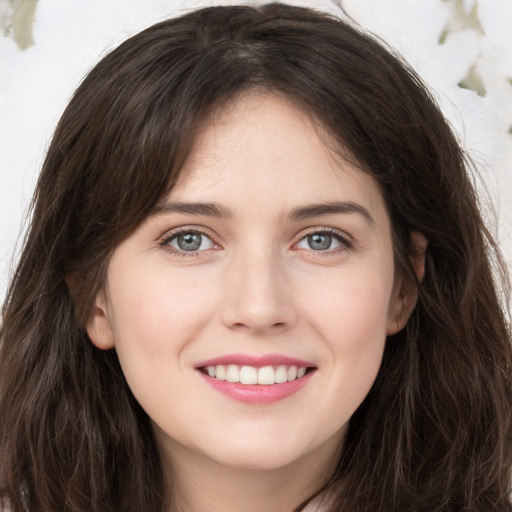 Joyful white young-adult female with long  brown hair and grey eyes