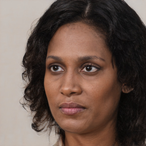Neutral black young-adult female with medium  brown hair and brown eyes