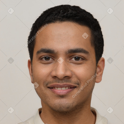 Joyful latino young-adult male with short  black hair and brown eyes