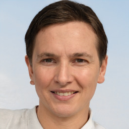 Joyful white adult male with short  brown hair and brown eyes