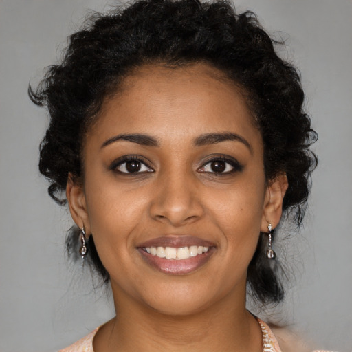 Joyful black young-adult female with medium  black hair and brown eyes