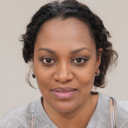 Joyful black adult female with medium  brown hair and brown eyes