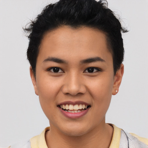 Joyful latino young-adult female with short  black hair and brown eyes