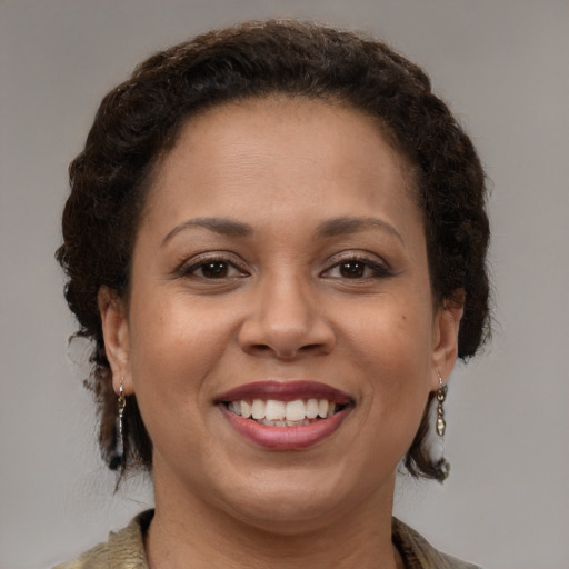Joyful black young-adult female with medium  brown hair and brown eyes