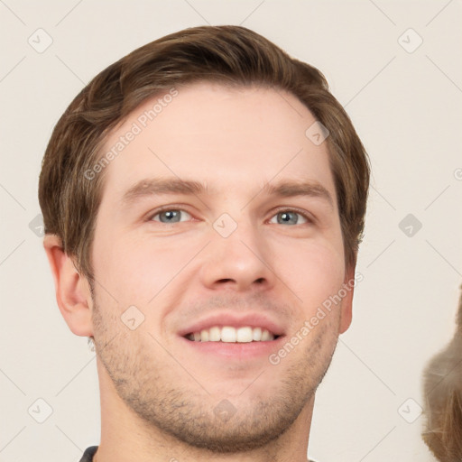 Joyful white young-adult male with short  brown hair and grey eyes