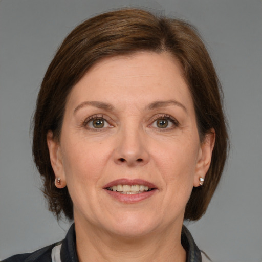 Joyful white adult female with medium  brown hair and grey eyes