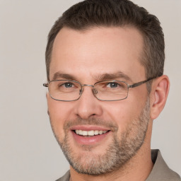 Joyful white adult male with short  brown hair and brown eyes